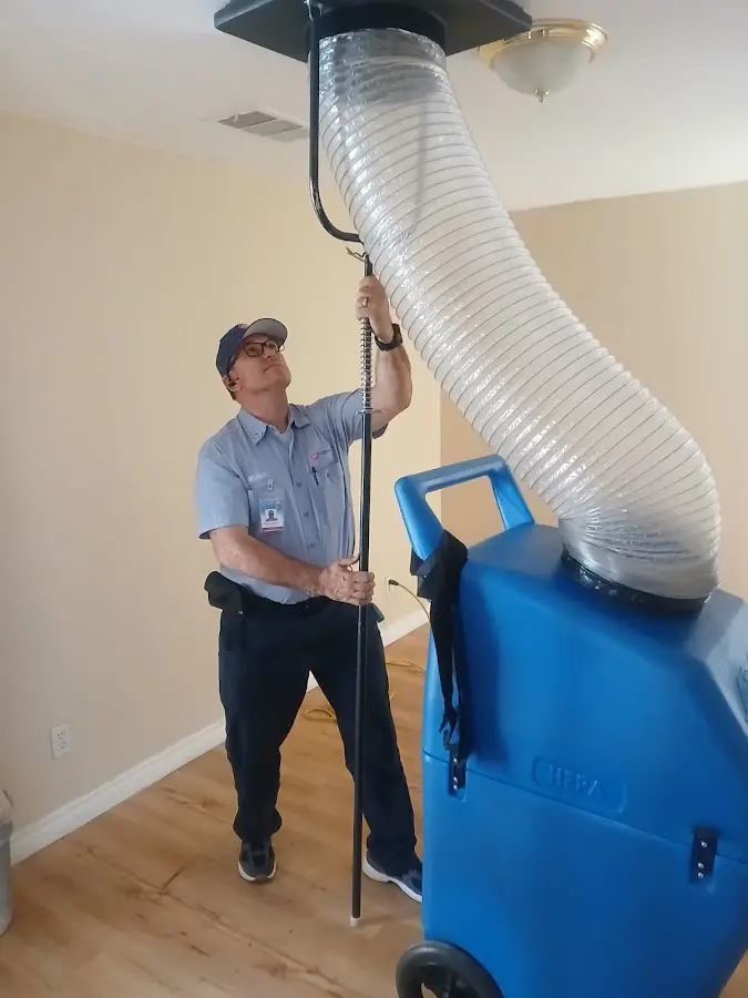 Furnace Tune-Up technician using HEPA equipment in Oakland